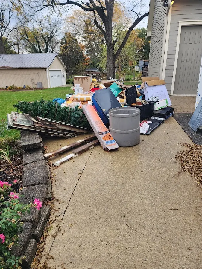 Dumpster being loaded with debris for Estate Cleanout Dumpster Rental in New Sewickley